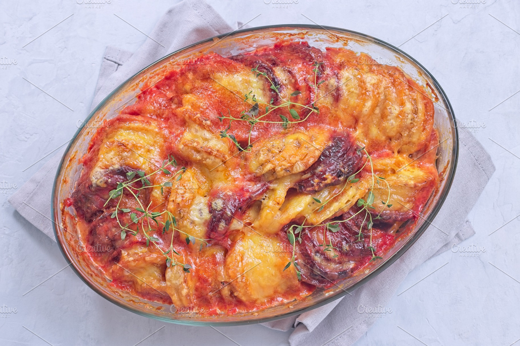 Sweet potato, parsnips and beet root au gratin with thyme and melted cheese, ho, a Food & Drink Photo by iuliia_n