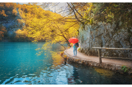 Woman with red umbrella on path, a Person Photo by den-belitsky