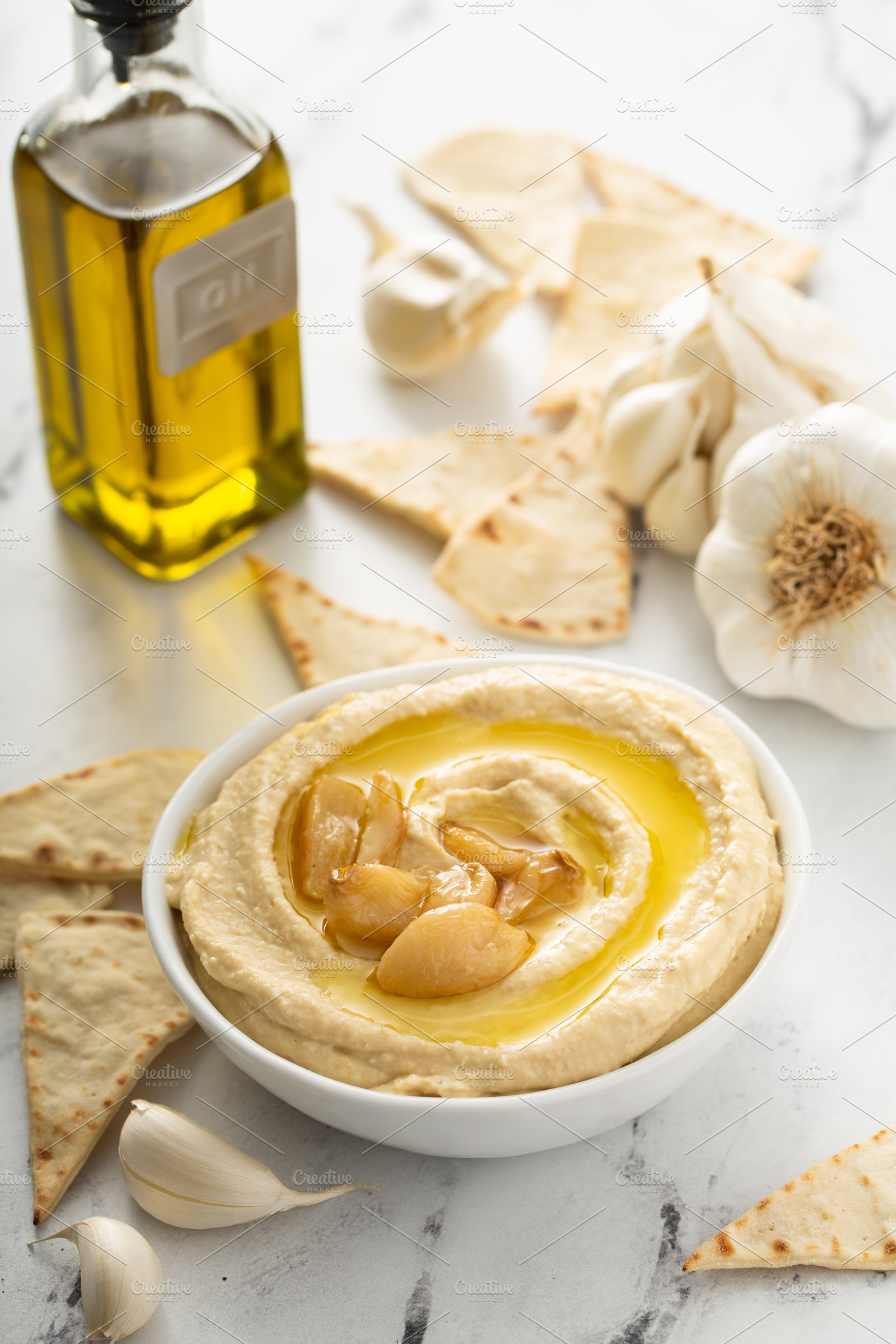 Roasted garlic hummus topped with olive oil, a Food & Drink Photo by farwasser