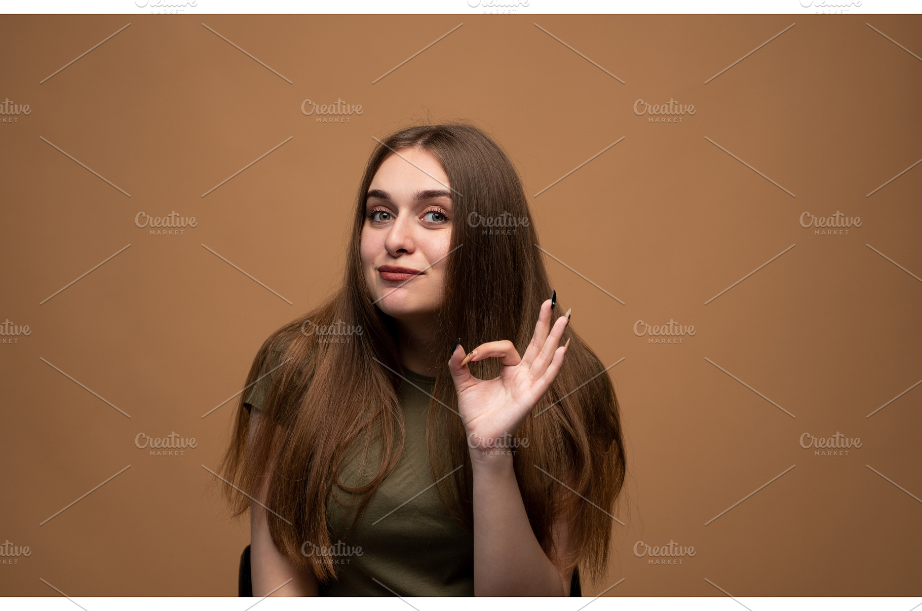 Young woman showing okay sign, a Person Photo by volodymyrshtun13795