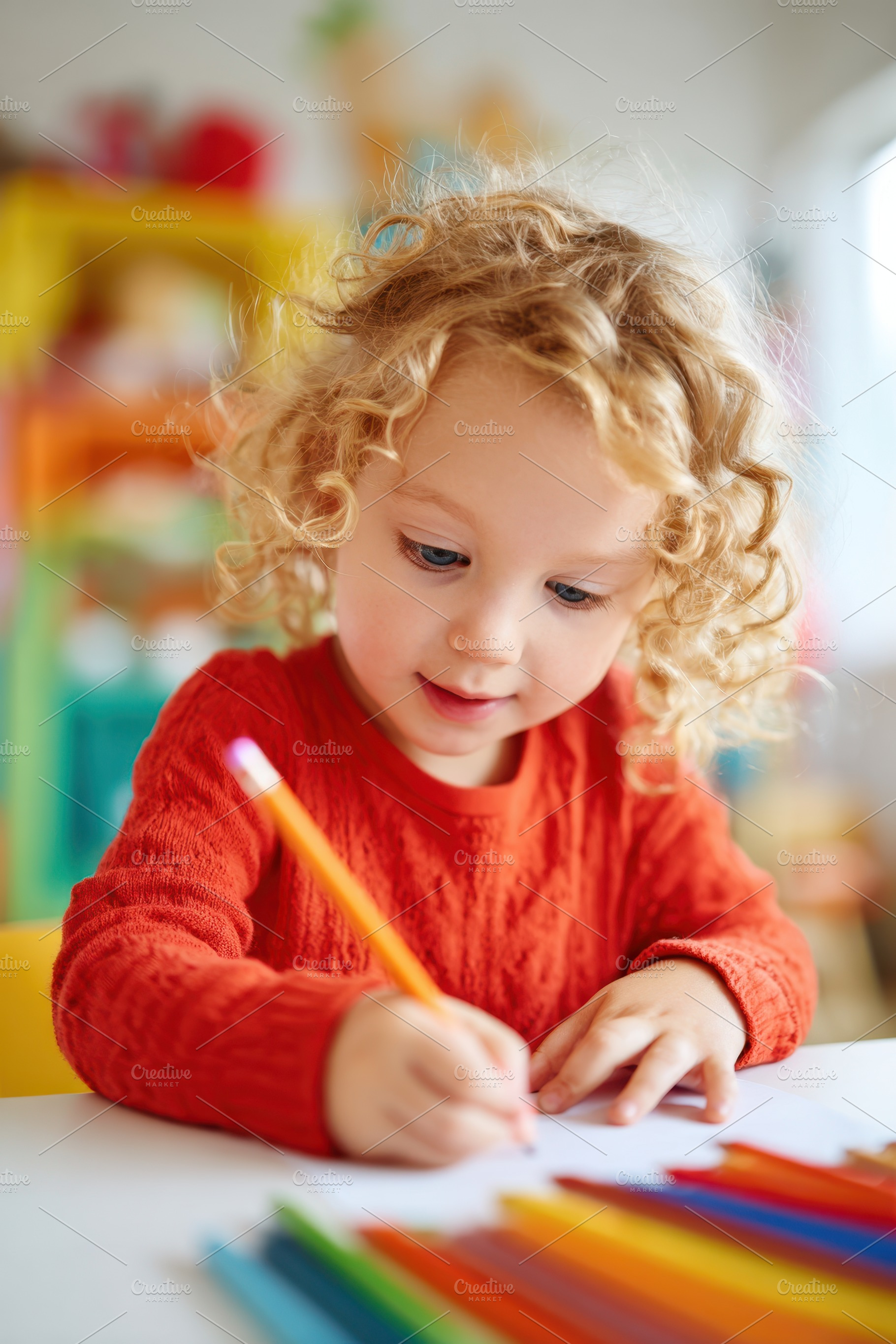 Child Drawing with Colored Pencils, a Person Photo by AlyaAnd