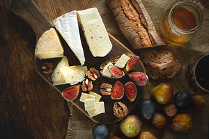 Assortment of cheeses, glass red