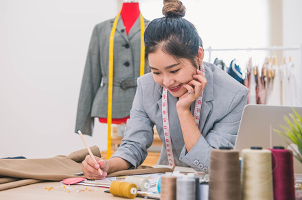 Attractive Asian female fashion designer  working in home office, a Beauty & Fashion Photo by Ministocker