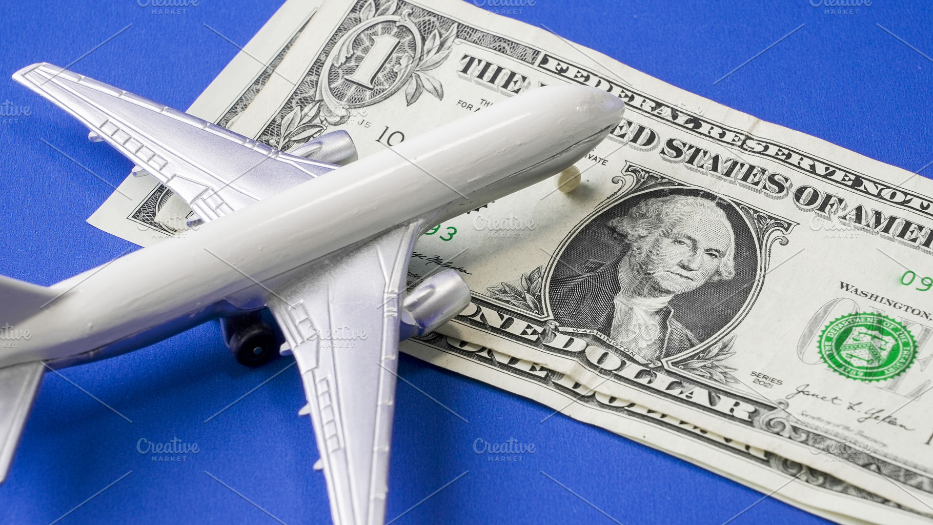 Model airplane resting on one dollar, a Transportation Photo by 1miromiro