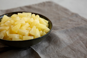 Canned Pineapple Tidbit Chunks in a Bowl, side view. Copy space., a Food & Drink Photo by LiudmylaChuhunova