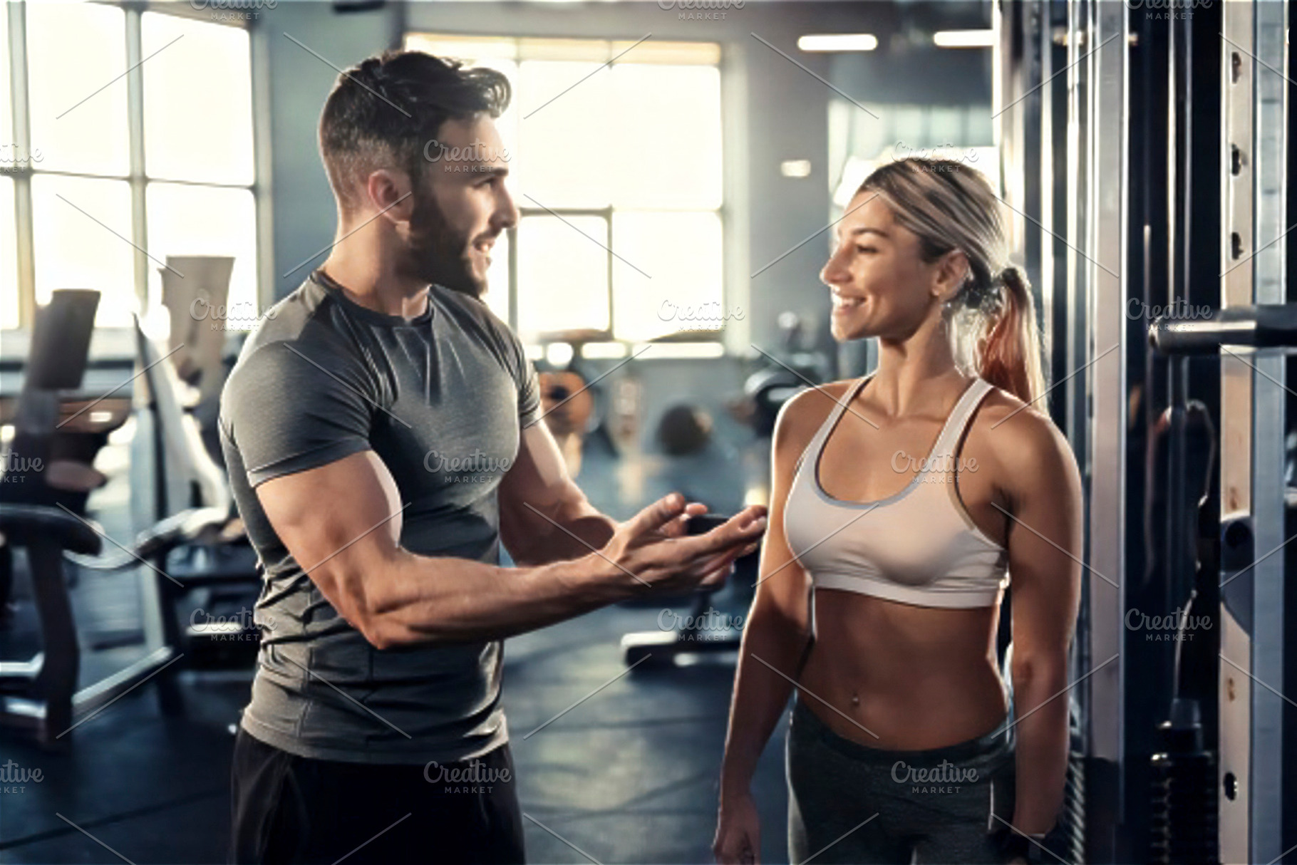 Personal trainer talking with client a interior of modern gym, a Sports & Recreation Photo by DanFLCreativo