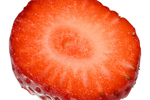Round piece of ripe red strawberry on isolated background, a Food & Drink Photo by ndanko