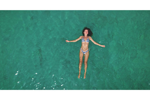 Woman relaxing floating on clear, a Person Photo by Goinyk