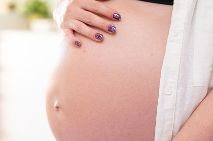 Closeup of a pregnant belly in studio lighting, a Person Photo by rubenchase
