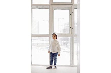 boy in a white sweater and hat, a Person Photo by SaulichPhoto