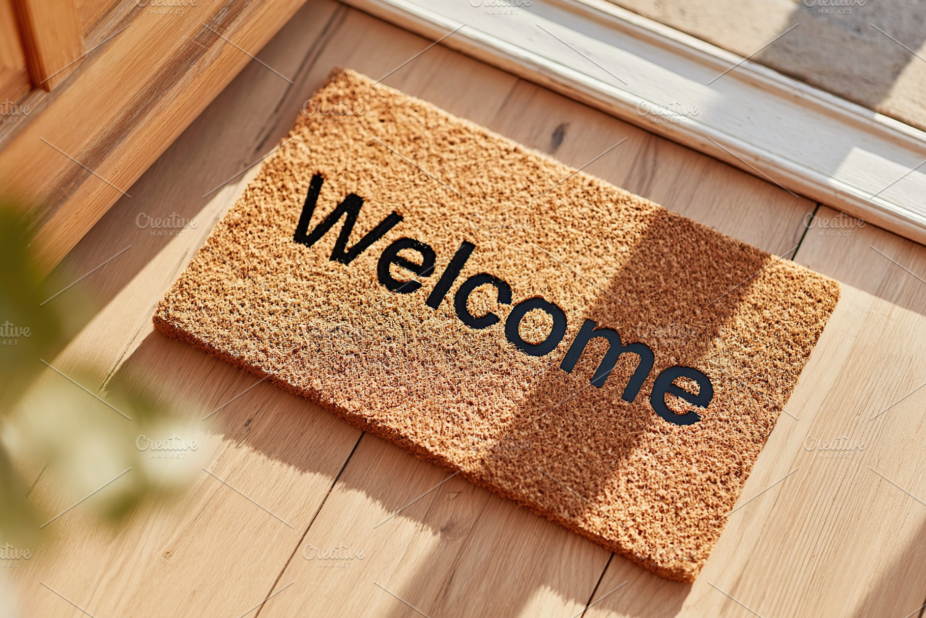 Cozy entrance mat with welcome message on wooden floor during sunny day, a Background Photo by AlyaAnd