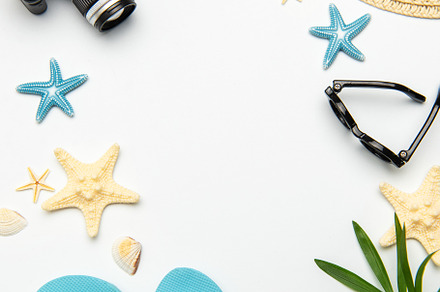 Summer accessories creating a frame on white background with cop