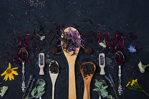 Different types of tea presented in the wooden and silver spoons stock photo