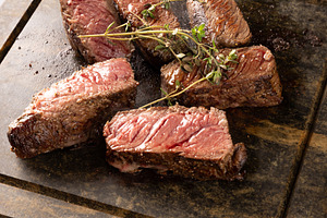Close up of juicy grilled steaks, a Photo by Grafvision photography