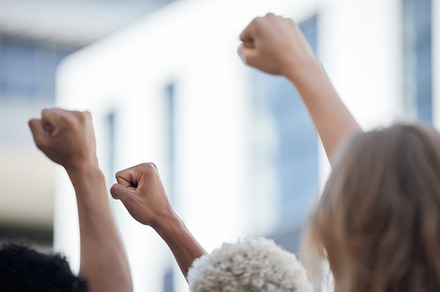 Fist, activism and solidarity, protest against racism and oppression, fight for diversity and equality. Unity, determined activist rally together for human rights violation and freedom of speech, a Photo by Peopleimages.com