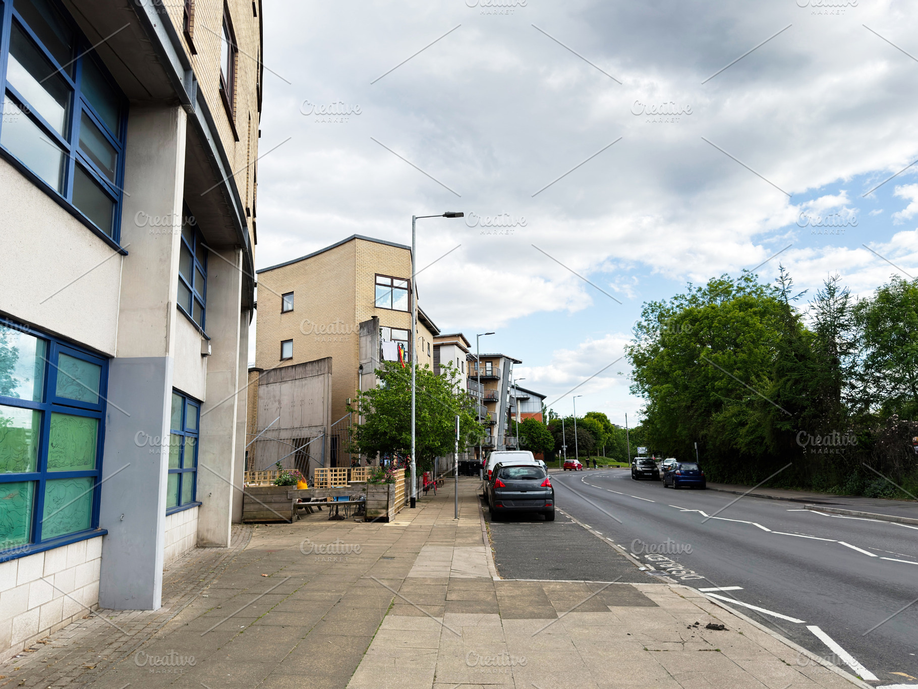 Quiet urban street in Manchester, UK with modern apartment build, a Photo by AS photostudio