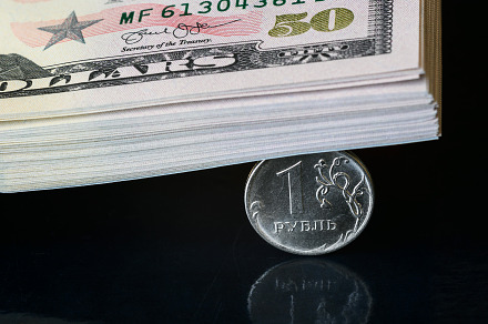 Russian ruble coin crushed by dollar, a Business Photo by Lopatin Photo