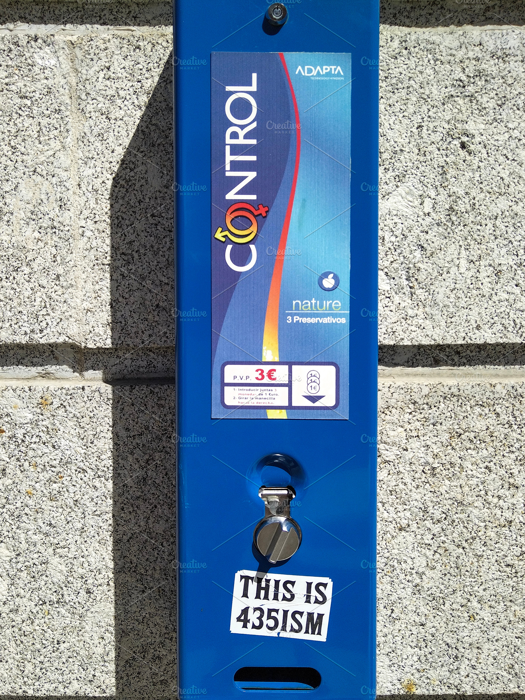 Condom dispenser on house wall, a Health & Medical Photo by DanFLCreativo