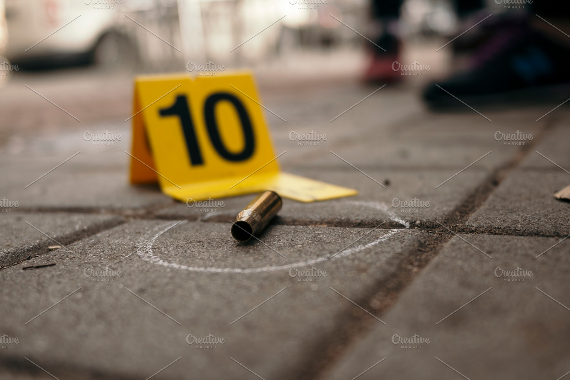 Bullet casing marked as evidence at crime scene, an Industrial Photo by karrastock