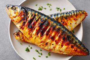 Grilled mackerel fillets served on a plate with fresh herbs and garnishes, a Food & Drink Photo by AlyaAnd