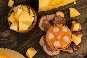 natural pumpkin juice with ice and pieces of pumpkin closeup, top view, a Photo by rsoollAI