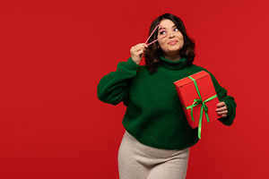 Woman holding gift box and candy, a Holiday Photo by Elena Vagengeim