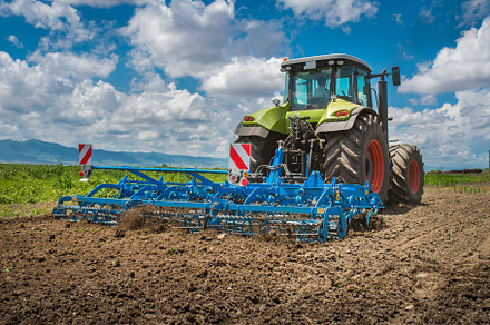 Land cultivation by the tractor, an Industrial Photo by David Khelashvili
