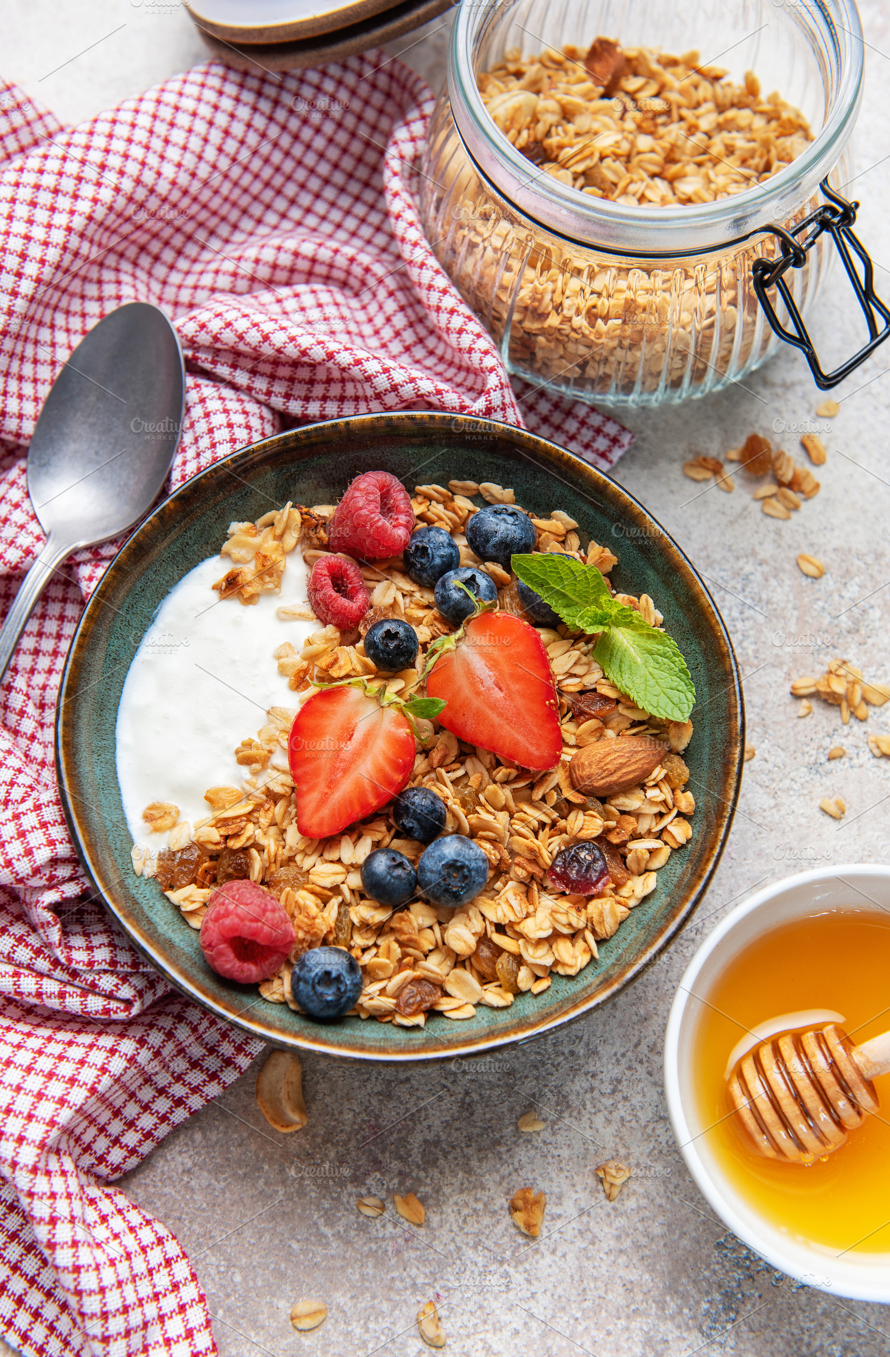 Granola yogurt parfait with fresh berries and honey, a Food & Drink Photo by Olena Rudo