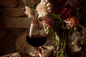 Red wine and cheese tasting with a floral arrangement, enjoying a rustic evenin, a Food & Drink Photo by Studio ANNA