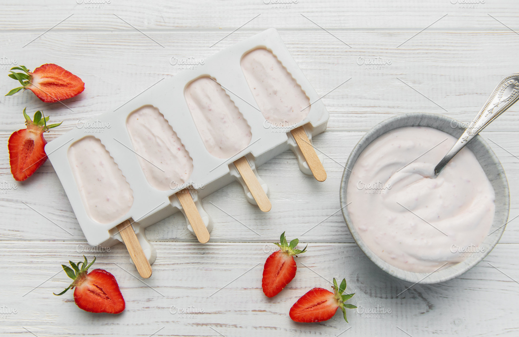 Homemade strawberry yogurt popsicles chilling in mold, a Food & Drink Photo by Olena Rudo