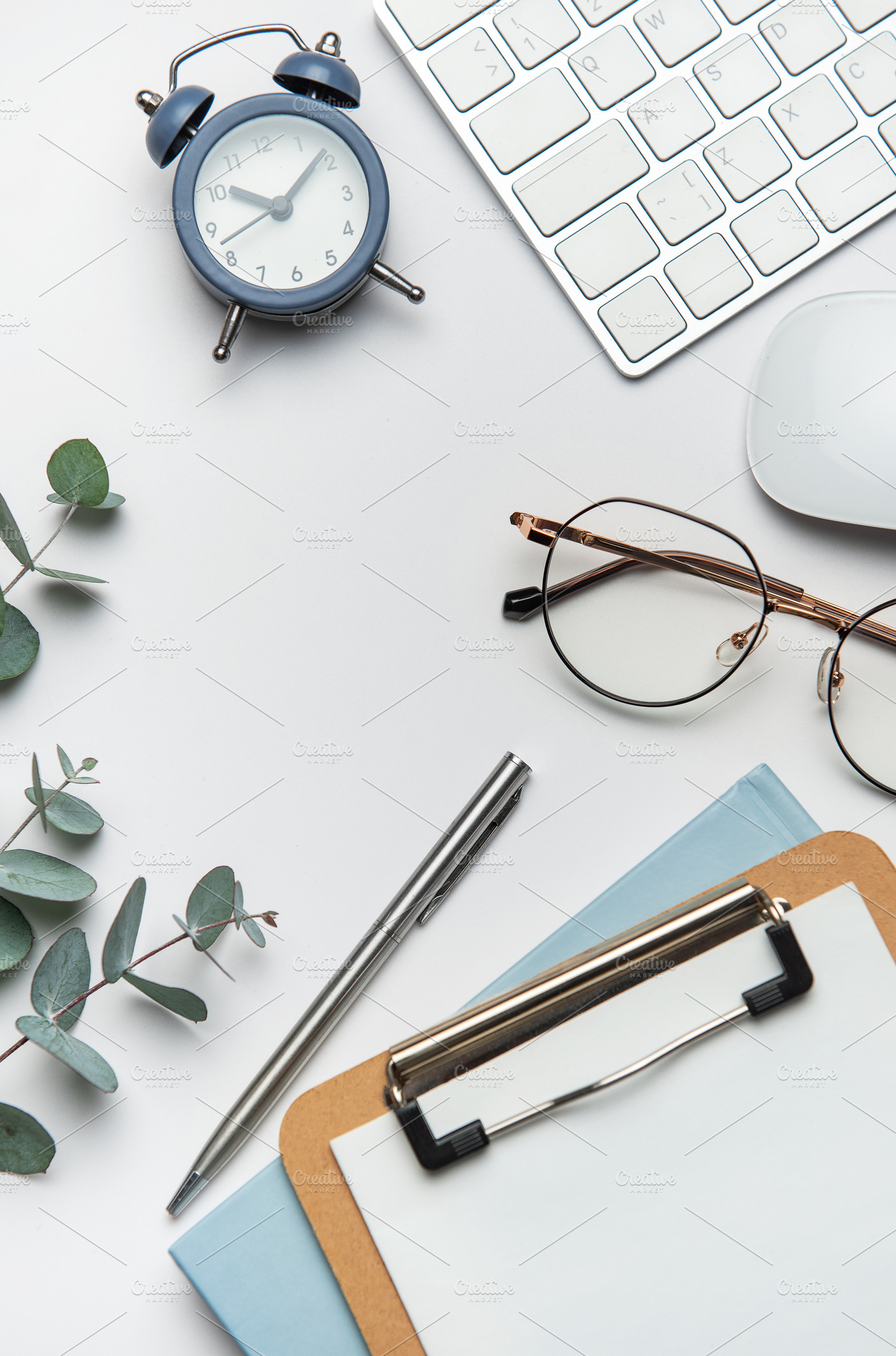 Workspace organizing eucalyptus branches, keyboard, mouse, alarm, a Business Photo by Olena Rudo