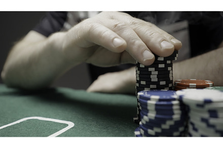Poker players at a green table with, a Person Photo by Media Whale Stock