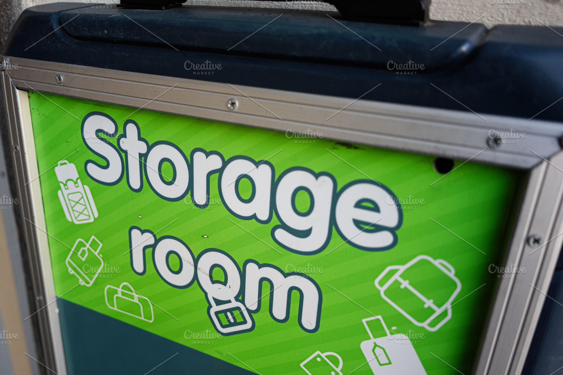 Green sign designating a storage room for bags and luggage in a facility., a Photo by AS photostudio