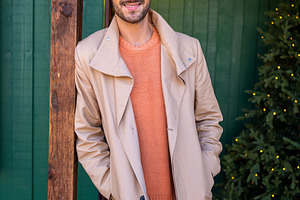 Handsome man in beige trench coat standing with hands in pockets, a Person Photo by andreonegin market