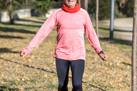 Senior man doing fitness exercises outdoors in autumn park