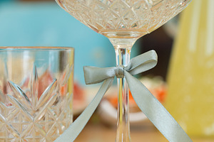 Close-up of elegant crystal champagne coupe with decorative satin ribbon., a Food & Drink Photo by Rohan Photography