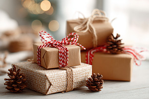 Beautifully wrapped holiday gifts with pine cones, a Holiday Photo by AlyaAnd