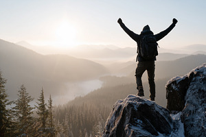 Man with backpack standing on snowy, a Nature Photo by MistyDay