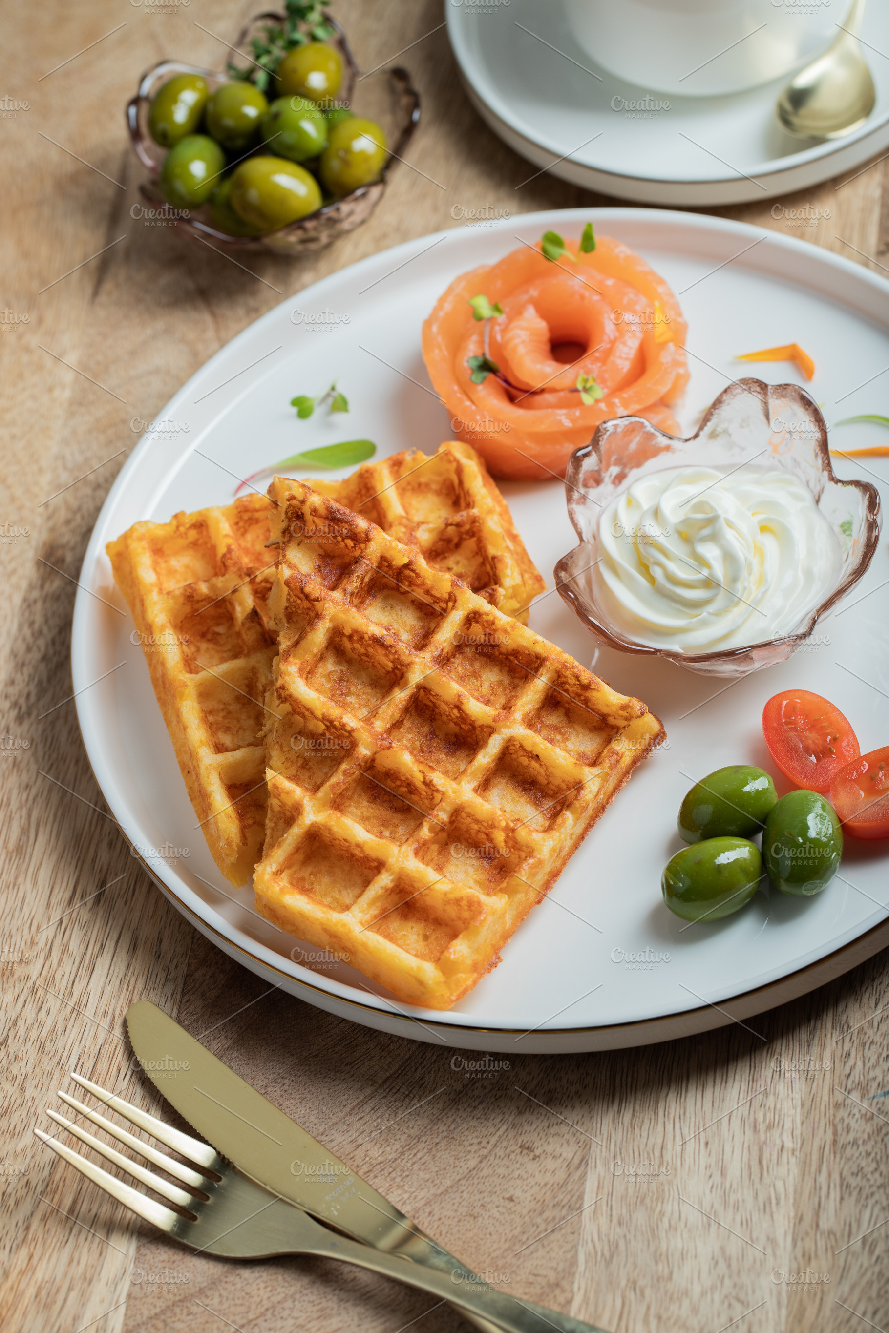Crunchy waffle fries with sour cream dip served in a basket, a Food & Drink Photo by Budarinphoto