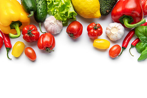 Fresh vibrant farm vegetables forming border on white, a Food & Drink Photo by Olena Rudo