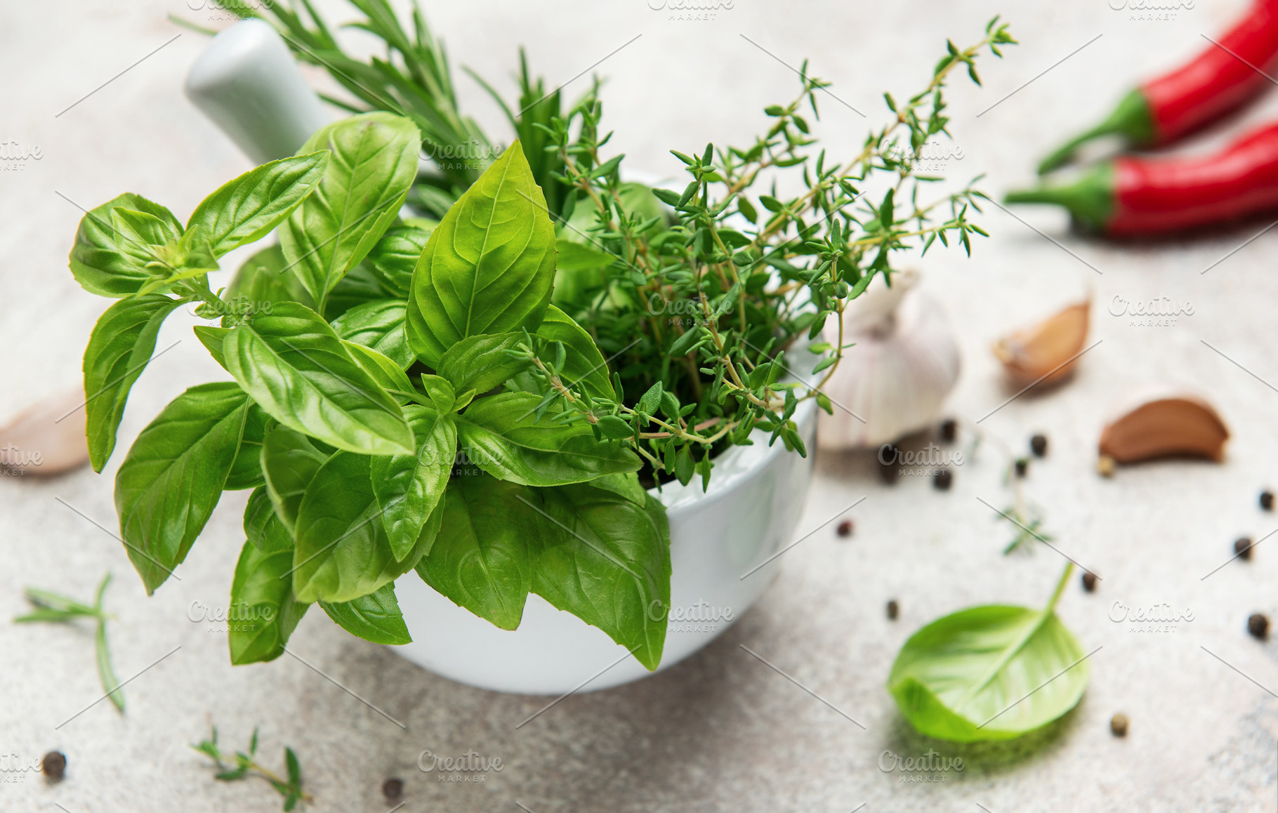 Fresh green herbs and spices in mortar with pestle for seasoning, a Food & Drink Photo by Olena Rudo