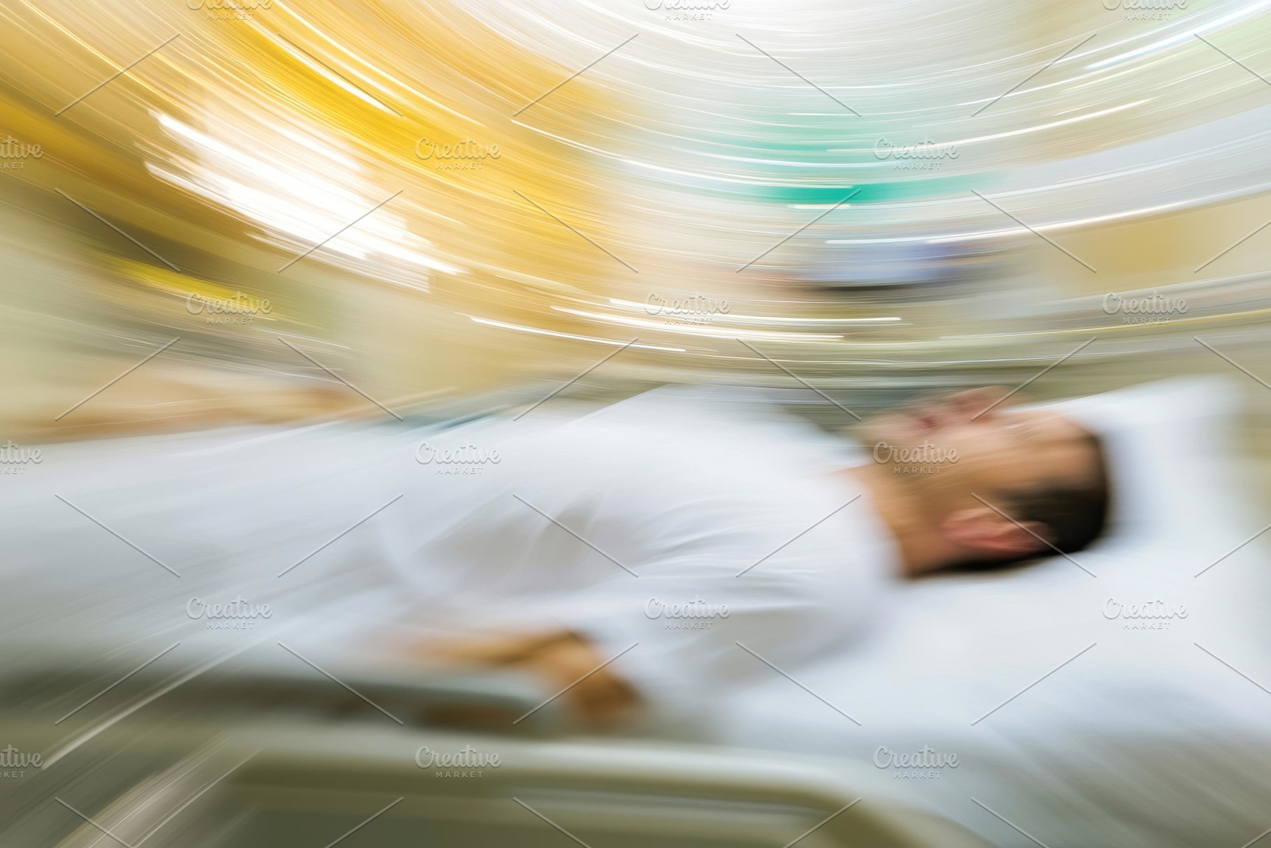 Patient lying on a hospital bed with, a Photo by Tanuart