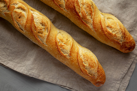Homemade French Bread Baguette on a gray background, top view., a Food & Drink Photo by LiudmylaChuhunova