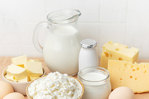 Assortment of fresh dairy products and eggs on wooden background, a Food & Drink Photo by Olena Rudo