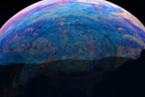 Close-up of a soap bubble with vibrant, swirling patterns and co, a Person Photo by Ales Munt