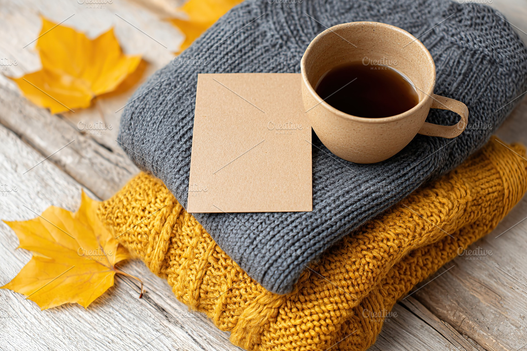 Cozy autumn mockup featuring warm clothing, a cup of coffee, and fallen leaves, a Food & Drink Photo by AlyaAnd