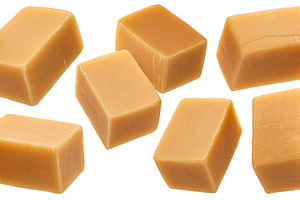 Caramel candies isolated on white, a Food & Drink Photo by Max Lashcheuski
