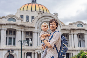 Father tourist lifting his little, an Architecture Photo by Elizaveta Galitskaya