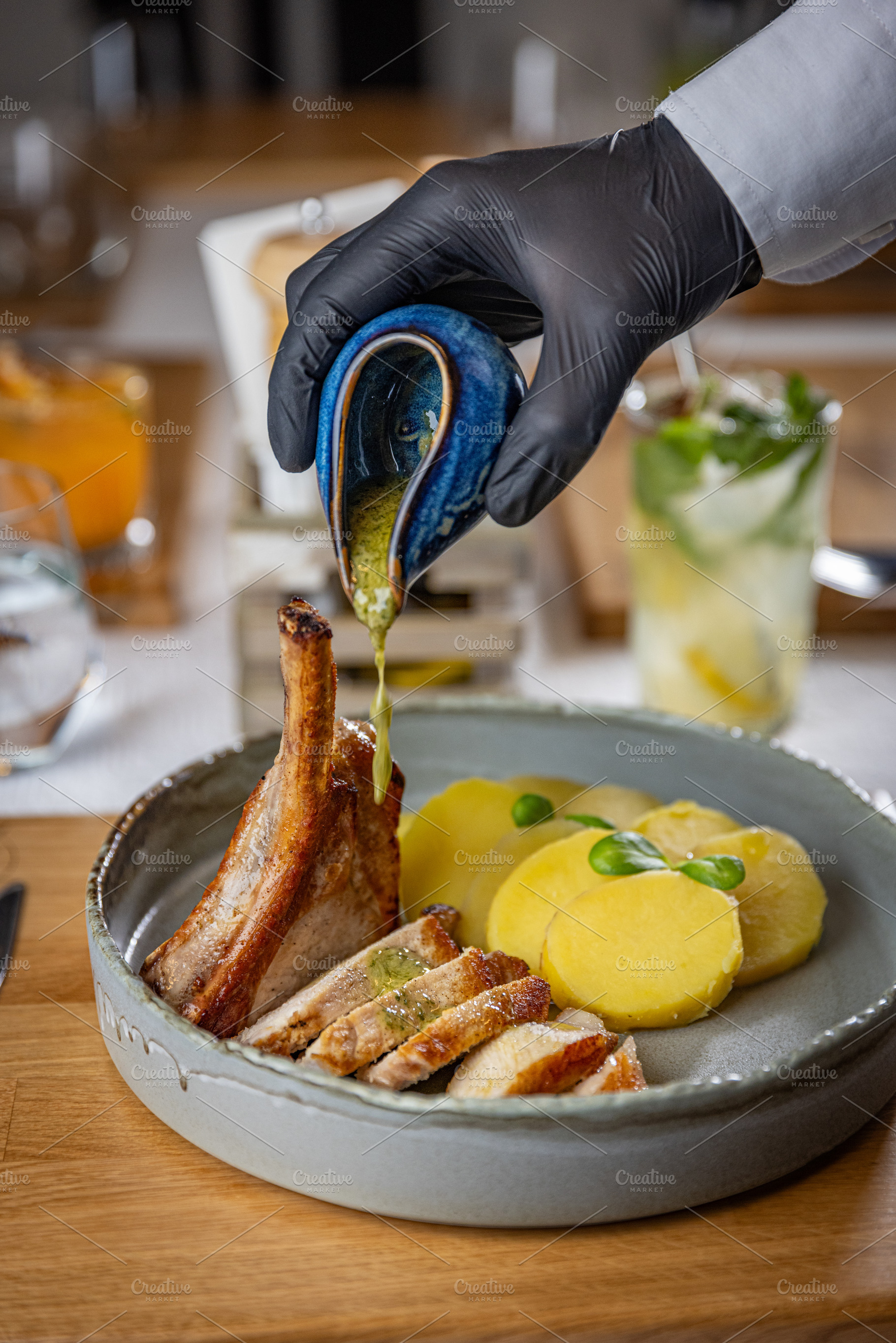 Chef pouring sauce on grilled pork ribs, a Photo by Grafvision photography