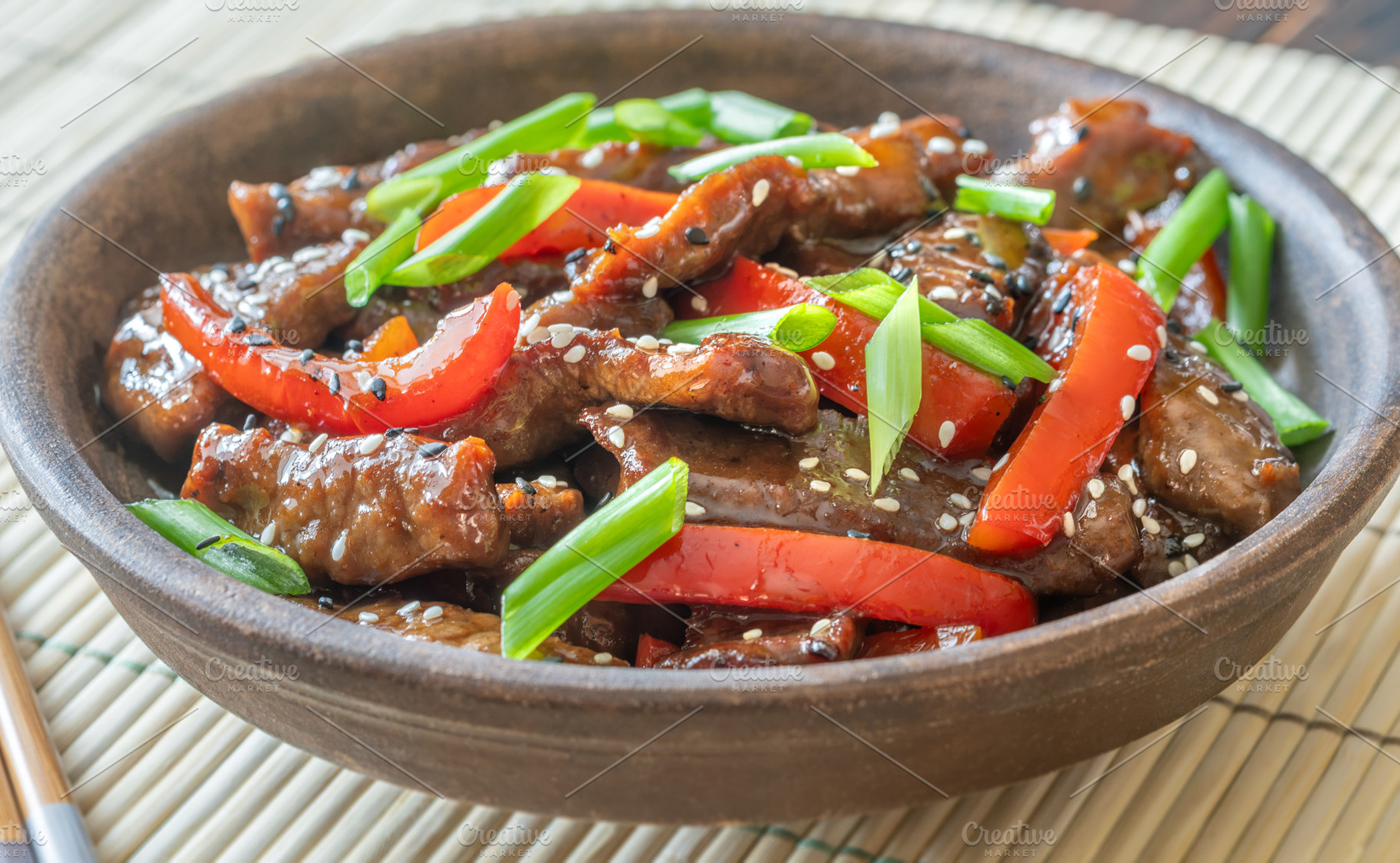 Chinese Beef Stir Fry With Red Peppers On Bamboo Mat Bright Pres, a Food & Drink Photo by Alexander Prokopenko